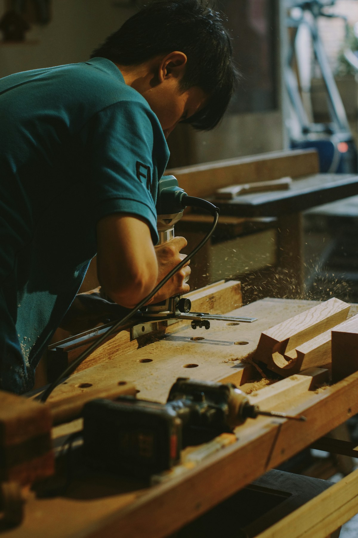 Craftsperson shaping timber in a woodworking workshop