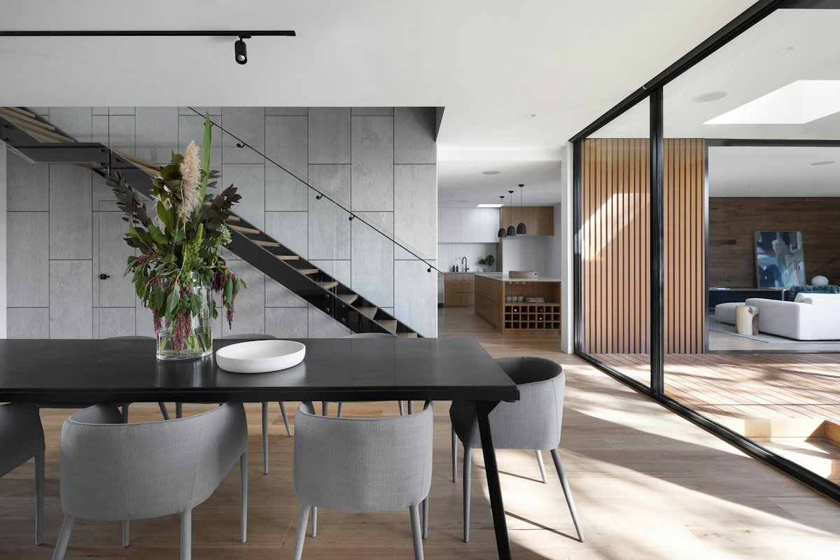 Modern dining and kitchen interior with timber accents